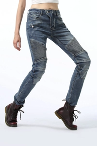 Detail view of blue motorcycle jeans with elastic knee pleats and decorative side zippers