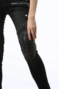 Detail of black motorcycle riding pants featuring reinforced knee protectors and breathable vents