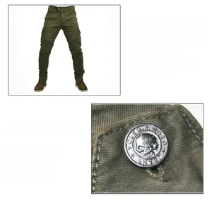 Detail of copper skull button and reinforced knee pleats on olive motorcycle jeans
