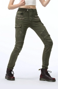 Close-up of olive green biker pants with pleated knee panels and utility zipper pockets