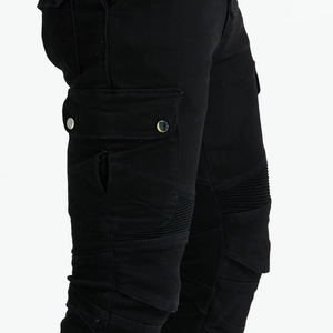 Detail of black motorcycle jeans with cargo pockets and pleated accordion knee panels