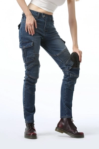 Detail of inserting protective pads into the pleated knee slots of green motorcycle jeans
