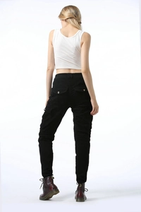 Detail of the multi-pocket cargo pants showing the back design and reinforced waist pleats