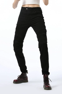 Detailed view of women's moto pants featuring pleated knee panels and black slim-fit denim