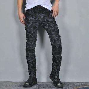 Detail view of cargo pockets and pleated knee panels on camouflage motorcycle pants