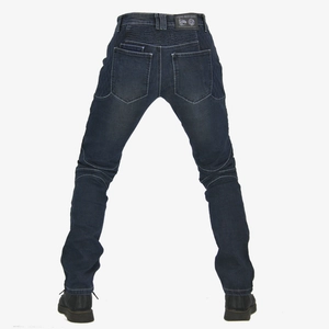 Detail view of denim motorcycle jeans with elastic accordion panels and leather logo patch