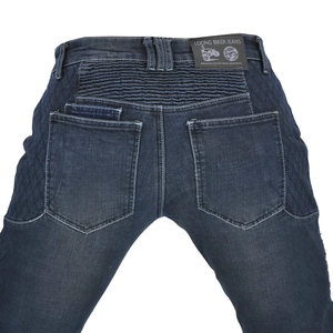 Detail of motorcycle jeans featuring accordion stretch panels and quilted reinforced fabric