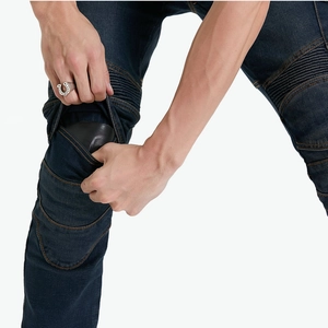 Detail view of motorcycle jeans with protective knee pads and flexible accordion panels