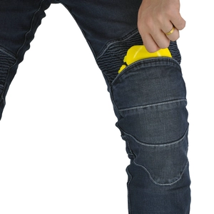 Close-up of flexible knee pleats and yellow armor pad insertion on blue motor jeans