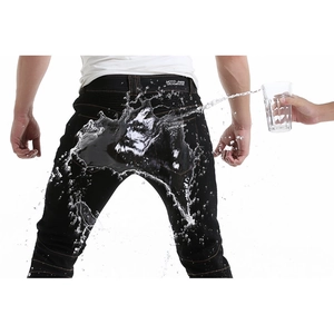 Waterproof motorcycle jeans showing active water resistance on stretch denim fabric