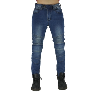 Detail of the biker-style blue denim stretch pants with ribbed accordion pleats at knees
