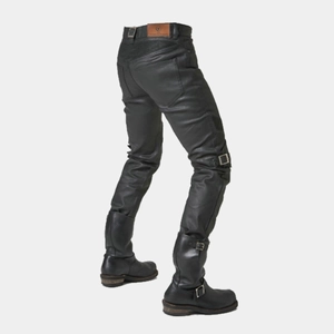 Detail of motorcycle pants with ribbed flex panels and leather logo patch on waistband
