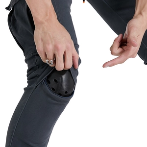 Close-up of detachable protective knee pads on grey motorcycle cargo pants for men