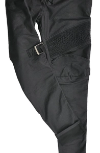 Macro detail of waterproof motorcycle jeans showing accordion pleats and metal buckle