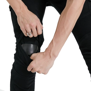 Detail of knee protective pad insertion into a black motorcycle riding denim pant