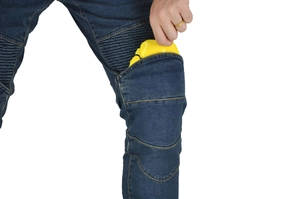 Detail showing the insertion of yellow protective armor into blue motorcycle riding jeans