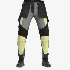 Detail of deconstructed patchwork motorcycle jeans featuring frayed edges and contrast panels