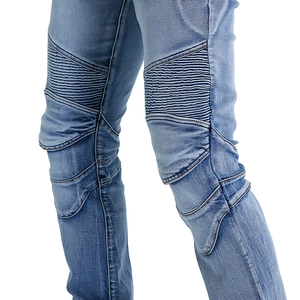 Close-up of ribbed stretch panels and reinforced stitching on blue motorcycle jeans