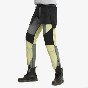 Detail of grey yellow patchwork motorcycle pants with asymmetric utility pockets