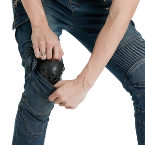 Detail showing the inner protective knee pad insert on dark blue motorcycle riding jeans