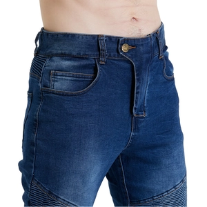 Detail of dark blue motorcycle jeans featuring protective biker pleats and metal button fly