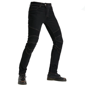 Detail of black motorcycle riding jeans featuring flexible ribbed stretch panels on thighs