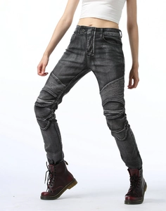 Close-up of women's biker jeans with ribbed panels and faded charcoal denim texture