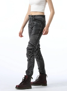 Macro detail of high-elastic grey washed biker jeans with ribbed knee panels