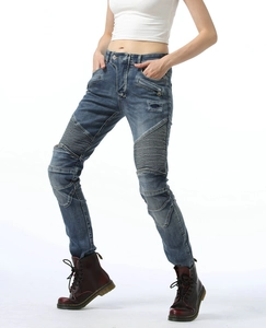 Moto-style denim pants detail with accordion stretch panels on knees and decorative zippers