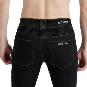 Detail of black motorcycle jeans featuring accordion stretch panels and logo embroidery