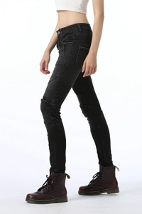 Detail of accordion pleated panels and white contrast stitching on black biker pants