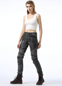 Detail of slim-fit motorcycle jeans for women featuring accordion pleats on the knees