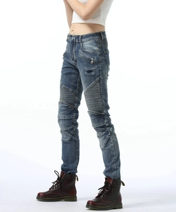 Detail of slim-fit biker denim pants with pleated knee panels and vintage wash