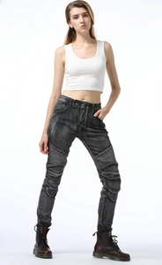 Detail of grey washed biker jeans showing accordion stretch panels on the knees and thighs
