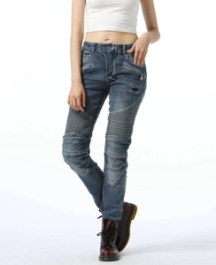 Detail of dark blue wash cotton biker jeans with pleated stretch panels for women