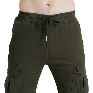 Detail of army green cargo pants featuring an elastic drawstring waist and large flap pockets