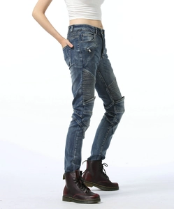 Detail of dark blue cotton biker jeans with pleated elastic panels and side zippers