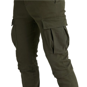 Detail of army green cargo pants featuring large tactical side pockets and knee stitching