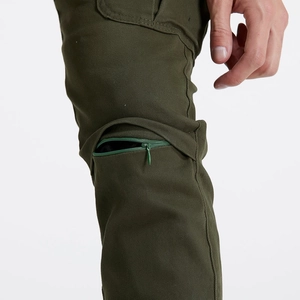 Detail of olive green cargo pants featuring a hidden zipper pocket and twill fabric texture