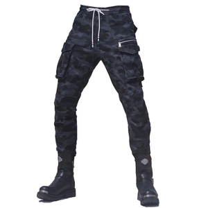 Detail of dark camouflage biker pants featuring multi-pocket design and metal zipper
