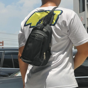 Outdoor shot of a black waterproof nylon drop leg bag with breathable mesh backing