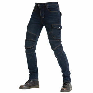 Detail of blue motorcycle denim pants featuring accordion stretch panels and cargo pockets