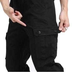 Detail of multi-pocket cargo pants showing functional flap pocket with dual buttons