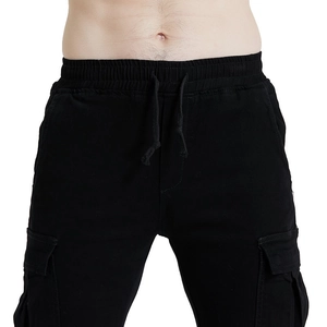 Detail of black cargo pants featuring elastic drawstring waist and durable cotton fabric