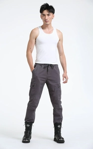 Detail of dark grey joggers featuring multi-pocket design and adjustable drawstring waist