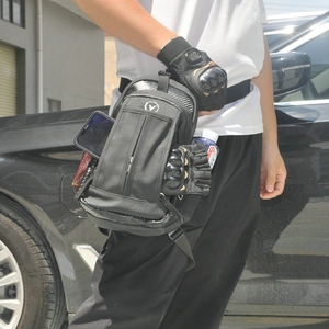 Waterproof motorcycle leg bag with carbon fiber texture shown in an outdoor riding scene