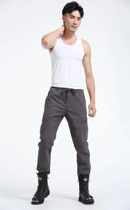Close-up of gray cargo pants featuring functional large side pockets and drawstring waist