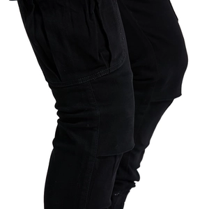 Detail of multi-pocket tactical cargo pants featuring reinforced stitching and matte fabric