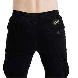 Rear view of black motorcycle cargo pants featuring elastic waist and large side pockets