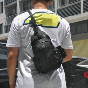 Detail view of black waterproof motorcycle leg bag with multiple pockets and carbon fiber accents